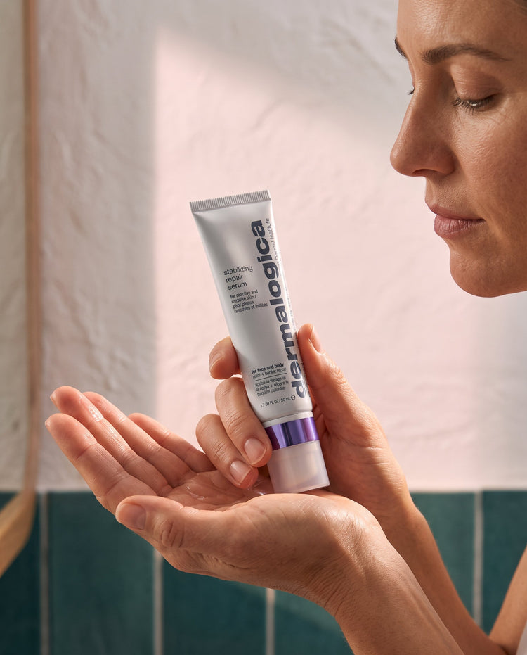 Person warming Dermalogica Stabilizing Repair Serum between their palms before applying it to their face