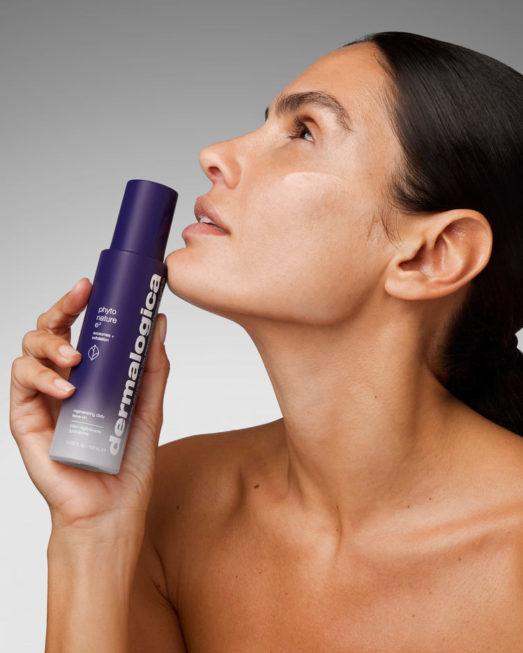 woman holding the dermalogica Phyto Nature E2 bottle up to her face